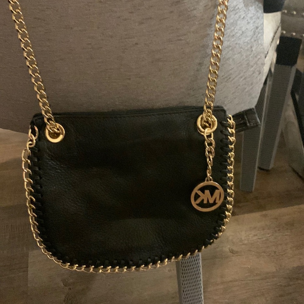 Michael kors small purse.   Shoulder strap or can be folded.  Brand new.